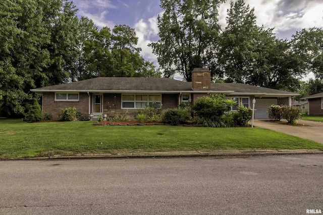 single story home featuring a garage and a front yard