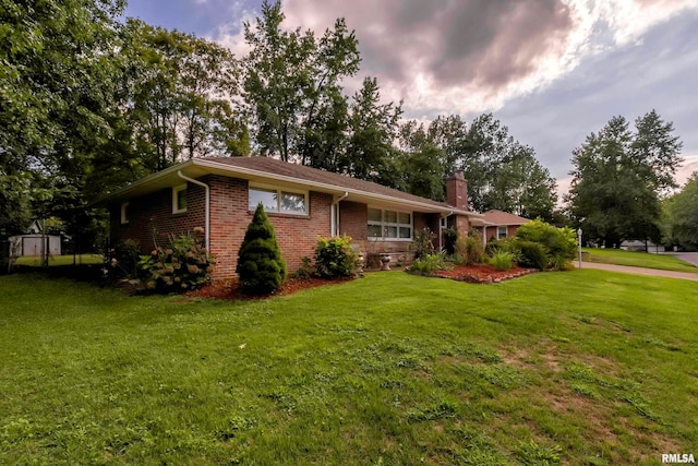 ranch-style house with a lawn