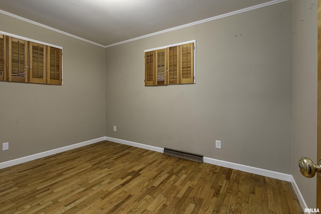 unfurnished room featuring crown molding and hardwood / wood-style floors