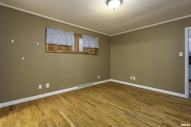 unfurnished room with crown molding and hardwood / wood-style flooring