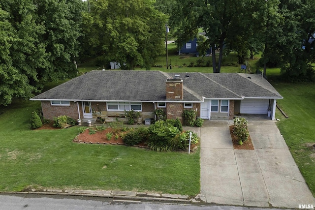 ranch-style home with a garage and a front lawn