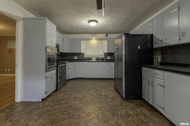 kitchen featuring sink, tasteful backsplash, a textured ceiling, appliances with stainless steel finishes, and white cabinets