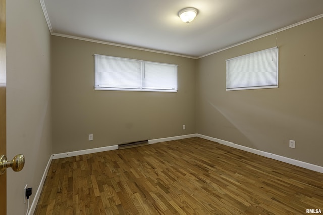 unfurnished room with hardwood / wood-style flooring and crown molding