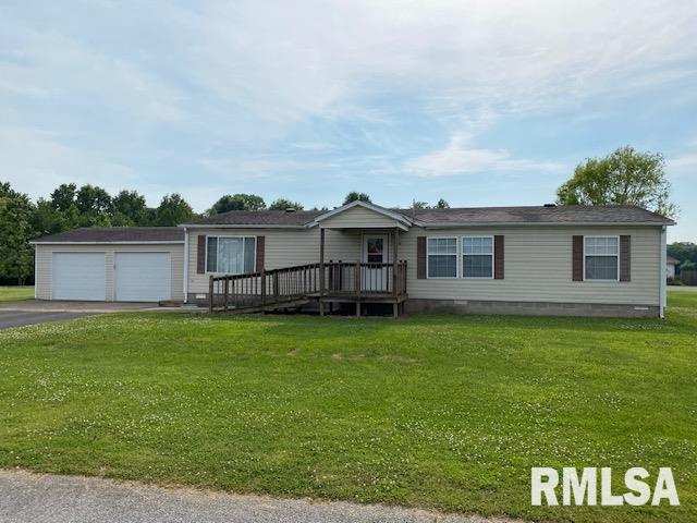 manufactured / mobile home featuring a front yard and a garage