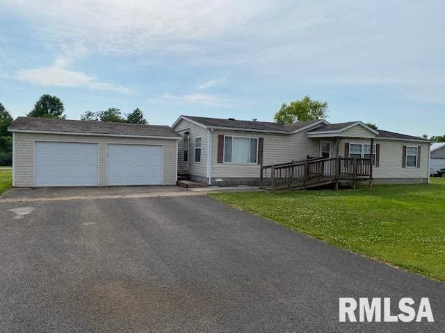 single story home with a garage, a front yard, and a deck