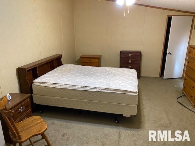 bedroom featuring lofted ceiling and carpet