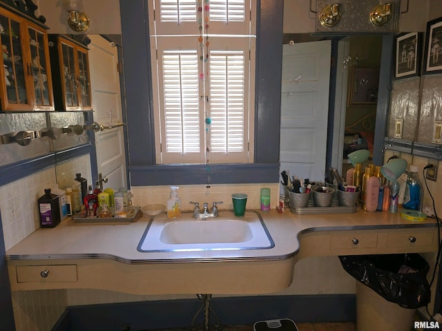 bathroom with tasteful backsplash and sink