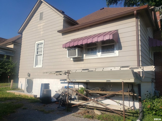 view of side of home featuring cooling unit