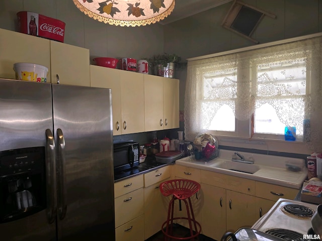 kitchen featuring stainless steel fridge and sink