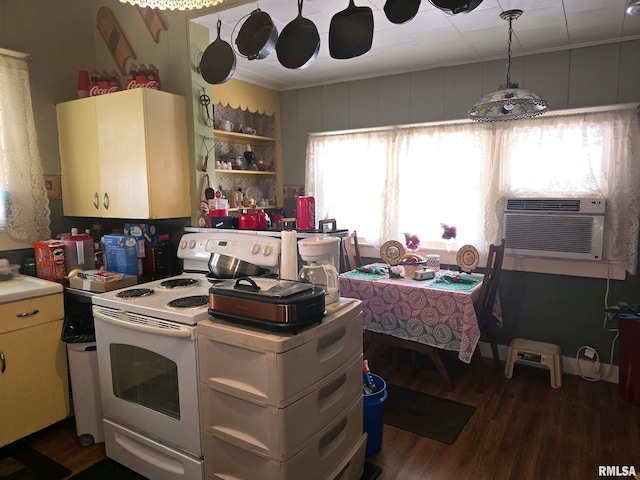 kitchen with dark wood-type flooring, cooling unit, electric range, ornamental molding, and decorative light fixtures