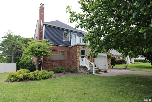 view of front of home featuring a front lawn, a garage, and a balcony