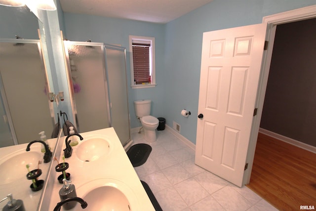 bathroom featuring a stall shower, a sink, and visible vents