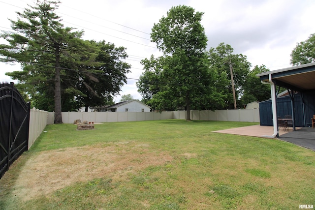 view of yard with a patio, an outdoor fire pit, and a fenced backyard