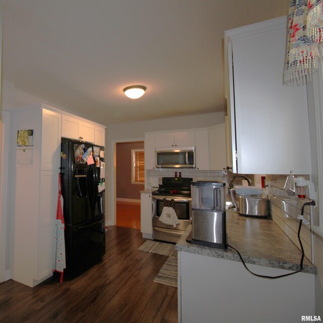 kitchen featuring dark wood-style floors, appliances with stainless steel finishes, white cabinets, and light countertops