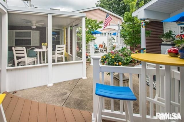 521 S Park Ave, Herrin, IL 62948 - wooden terrace with a sunroom