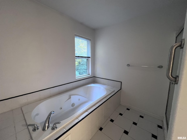 bathroom with tile patterned flooring and tiled bath