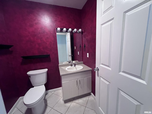 bathroom featuring tile patterned floors, vanity, and toilet