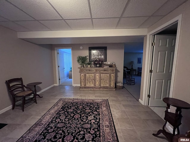 hall featuring a paneled ceiling