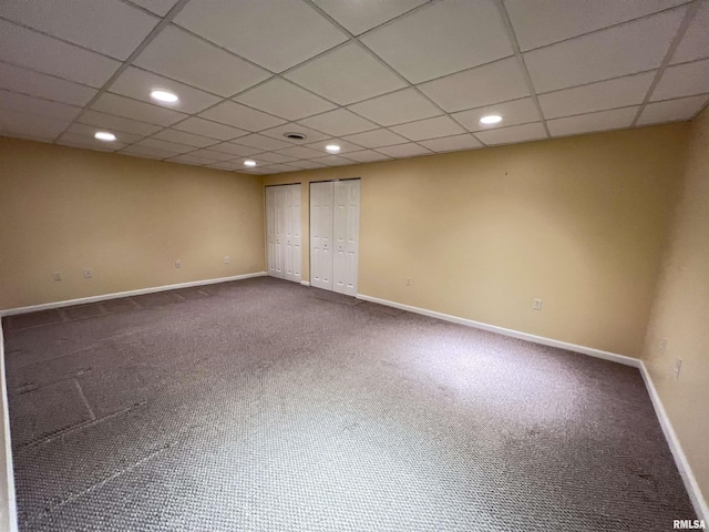 carpeted spare room with a paneled ceiling