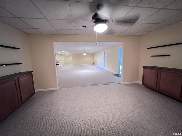 unfurnished room with light colored carpet and a drop ceiling