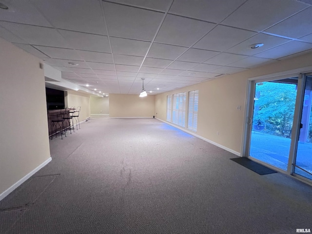 basement featuring carpet and a paneled ceiling