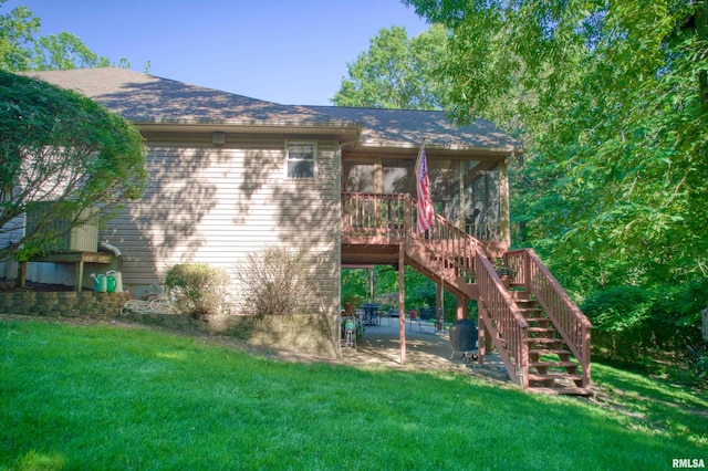 view of playground featuring a patio, a lawn, and a sunroom