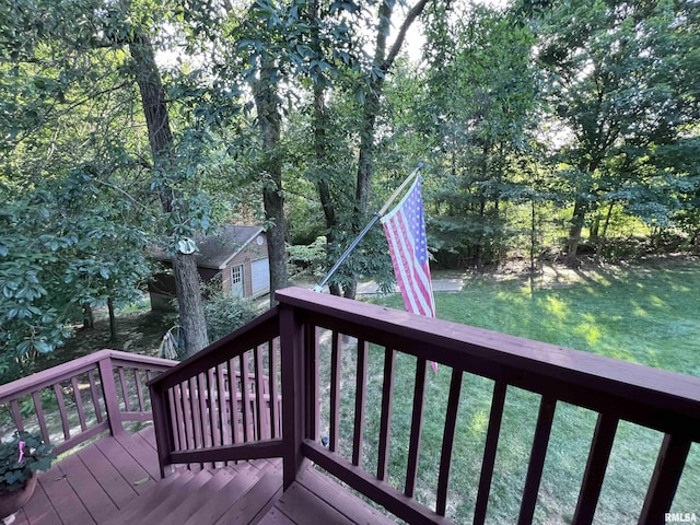 wooden terrace featuring a lawn