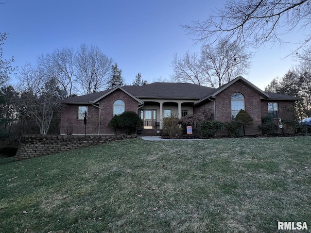 ranch-style home with a porch and a front lawn