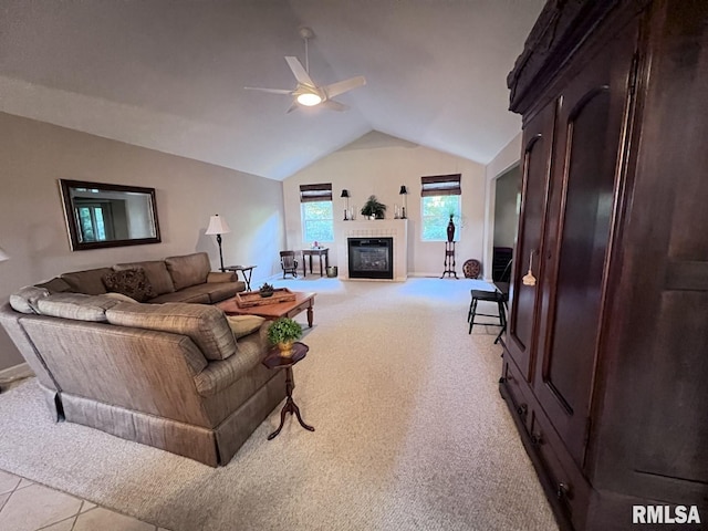 living room with ceiling fan, lofted ceiling, and light tile patterned floors