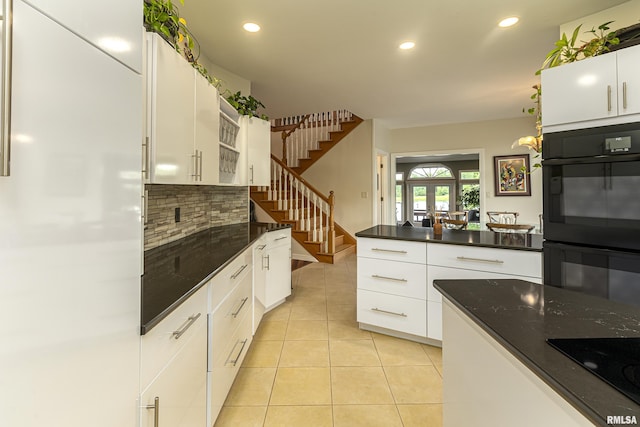 kitchen featuring french doors, tasteful backsplash, white cabinetry, and light tile patterned flooring