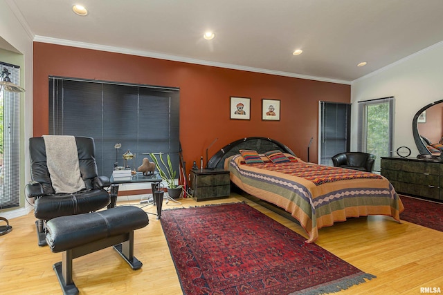 bedroom featuring hardwood / wood-style flooring and crown molding