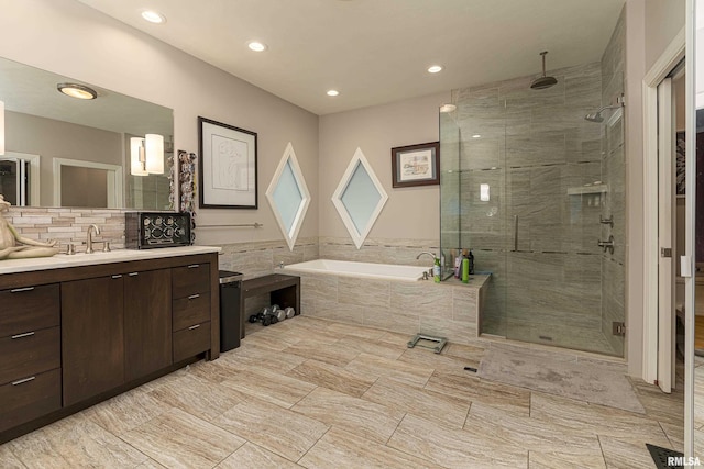 bathroom featuring vanity and separate shower and tub