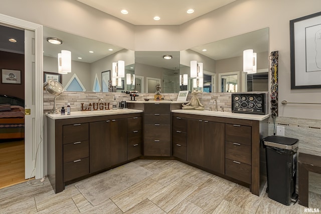 bathroom featuring vanity and backsplash