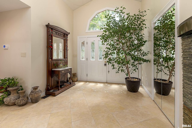 tiled entrance foyer with vaulted ceiling