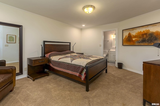 bedroom with connected bathroom and light colored carpet