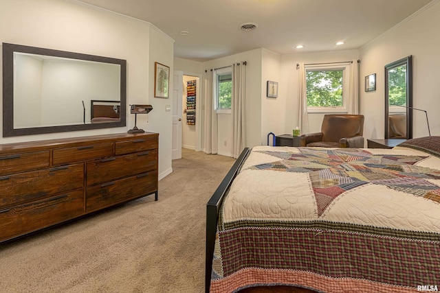 bedroom with ornamental molding and light carpet