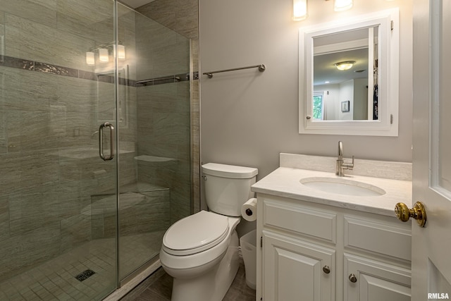 bathroom with toilet, vanity, and walk in shower