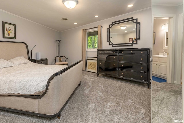 carpeted bedroom with ensuite bathroom, crown molding, and sink