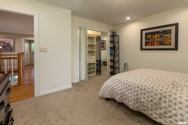 carpeted bedroom with multiple windows, a closet, and ornamental molding