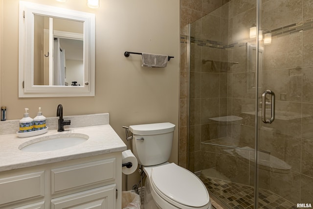 bathroom with vanity, toilet, and an enclosed shower