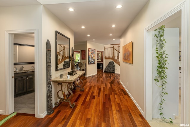 hallway with sink and dark wood-type flooring