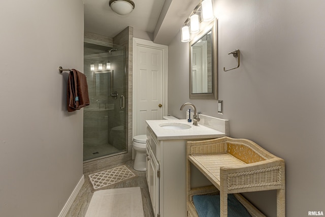 bathroom featuring vanity, toilet, and a shower with door