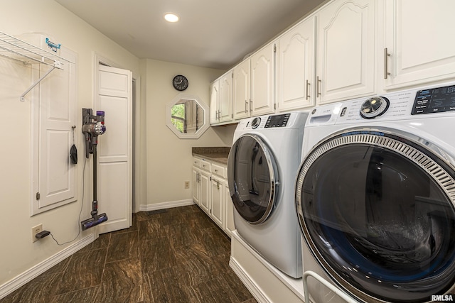 laundry room featuring cabinets and washing machine and dryer