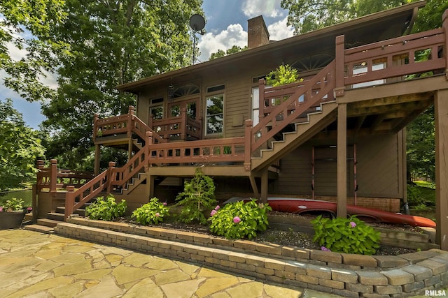 rear view of property with a wooden deck