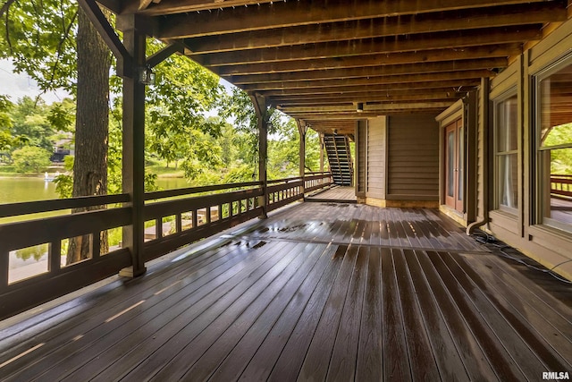 wooden terrace featuring a water view