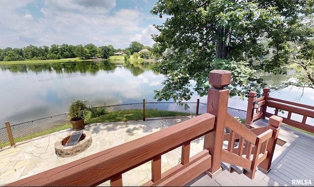 deck with a patio, a water view, and an outdoor fire pit