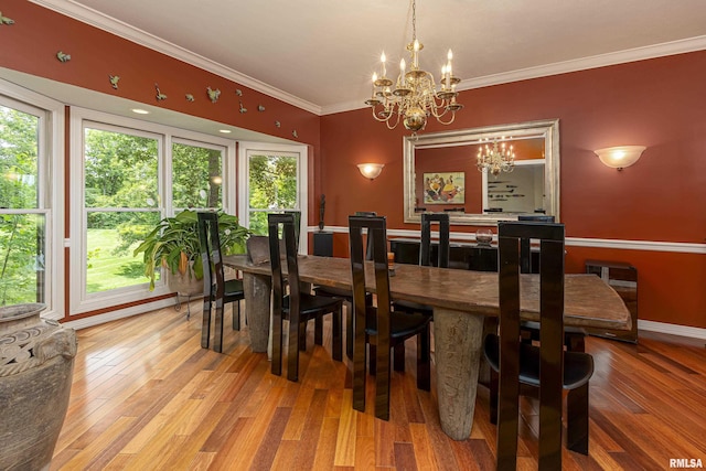 dining room featuring hardwood / wood-style flooring, an inviting chandelier, and crown molding