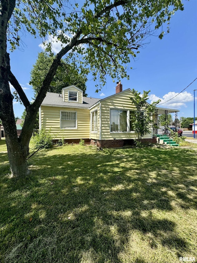 rear view of house with a lawn