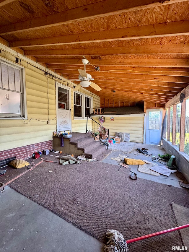 exterior space featuring ceiling fan and vaulted ceiling