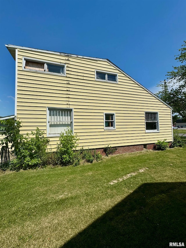 view of home's exterior with a lawn